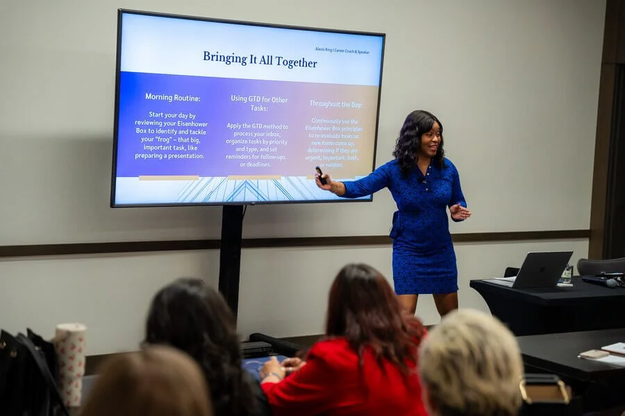 Alexis King speaking to an audience, mid-gesture